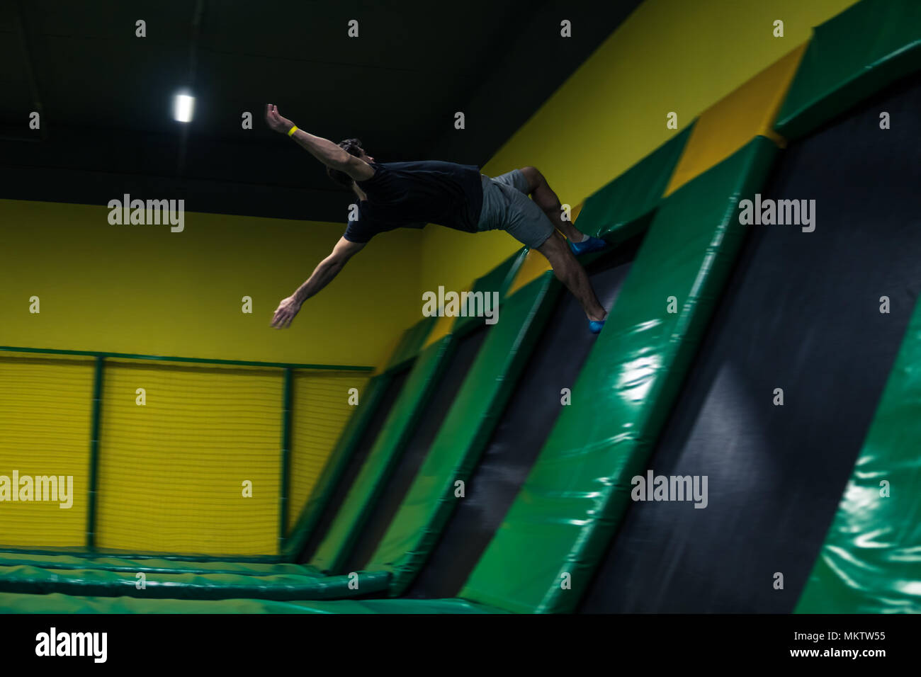 trampoline jumper performs acrobatic exercises on the trampoline Stock