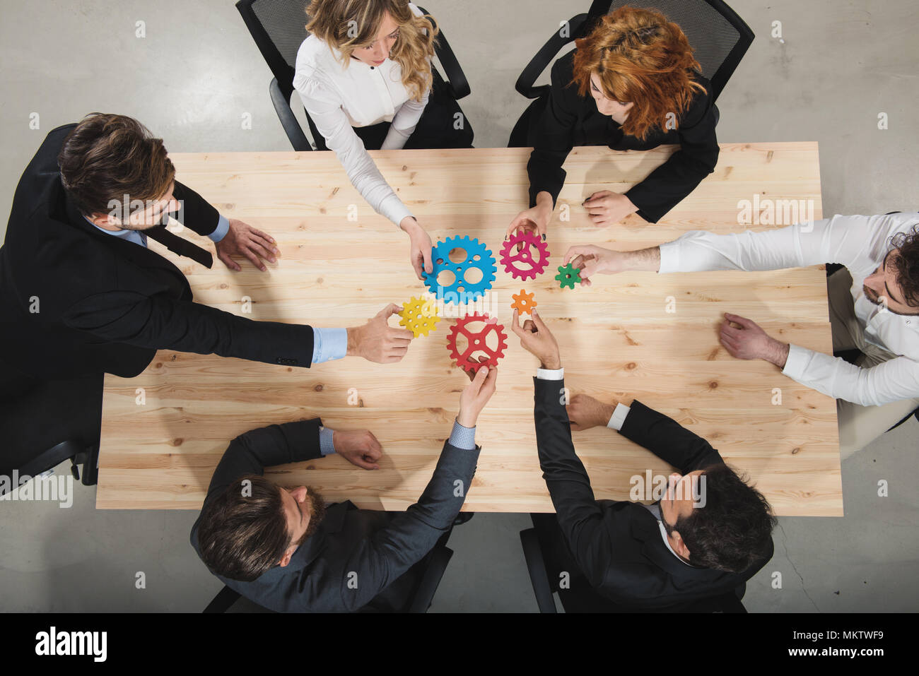 Business team connect pieces of gears. Teamwork, partnership and integration concept Stock Photo