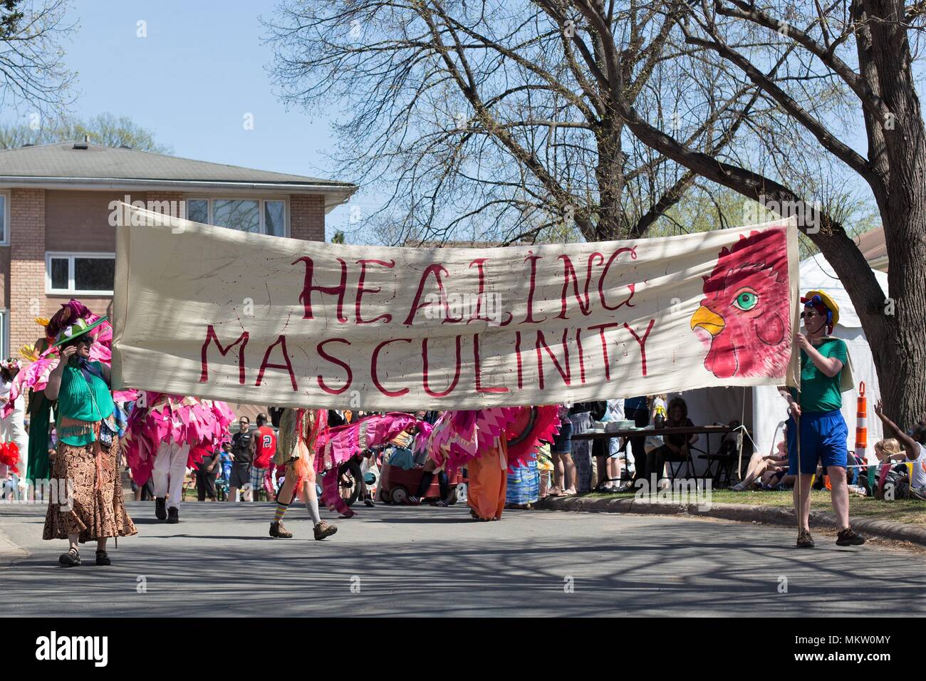 People holding a banner that reads 'Healing Masculinity' at the May Day parade and festival in Minneapolis, Minnesota, USA. Stock Photo