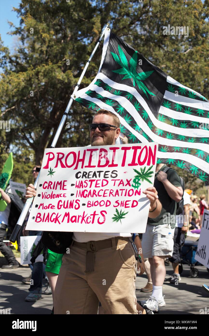 A man holding a sign supporting legalization of marijuana at the May Day parade and festival in Minneapolis, Minnesota, USA. Stock Photo