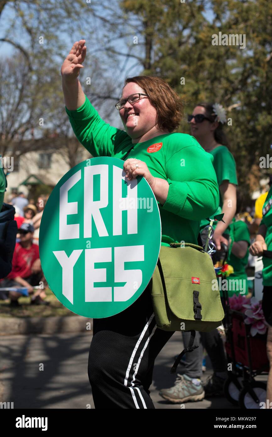 A woman holding an ERA sign at the May Day parade and festival in ...