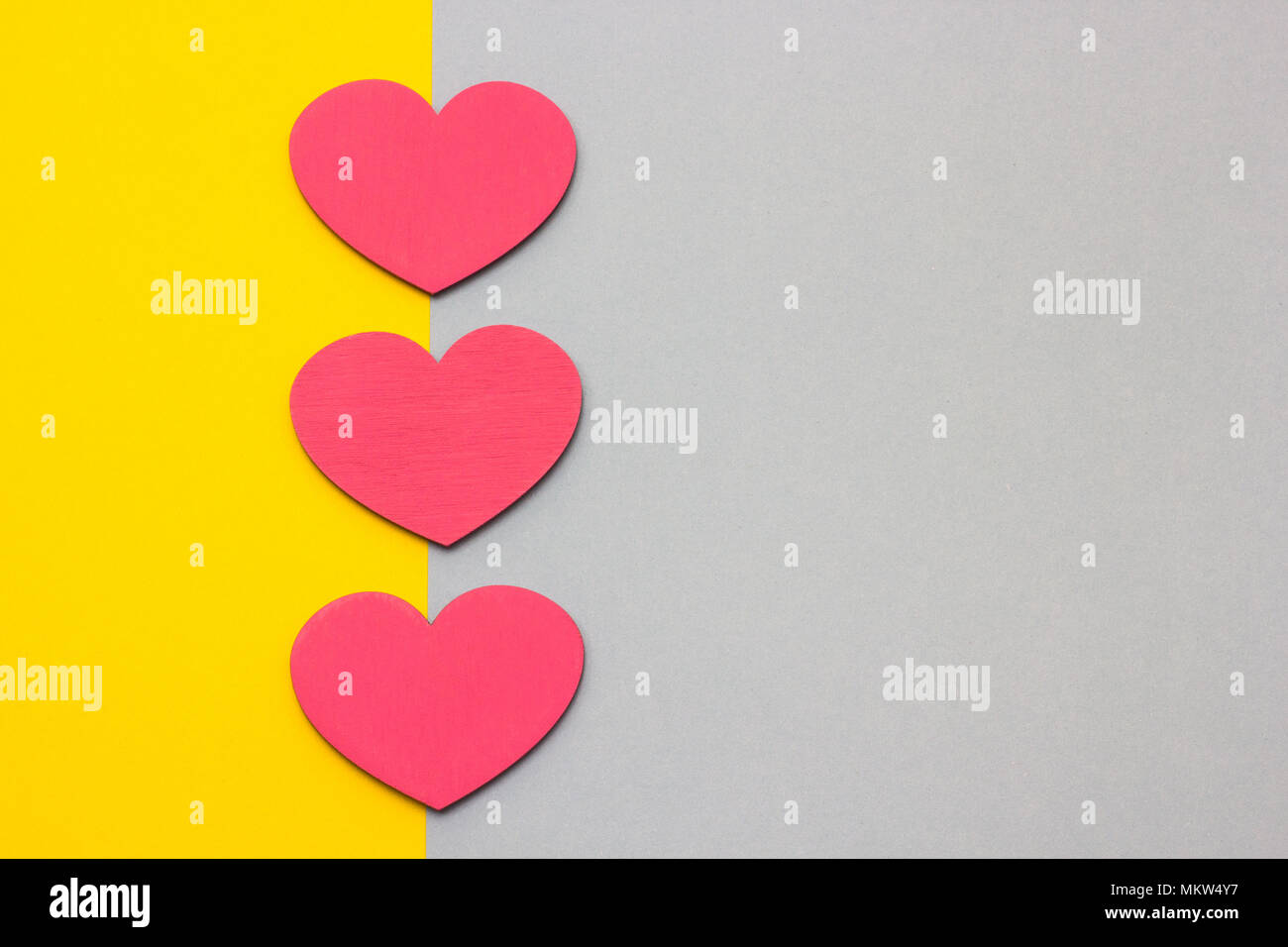 Wooden hearts on a multi-colored background, top view Stock Photo