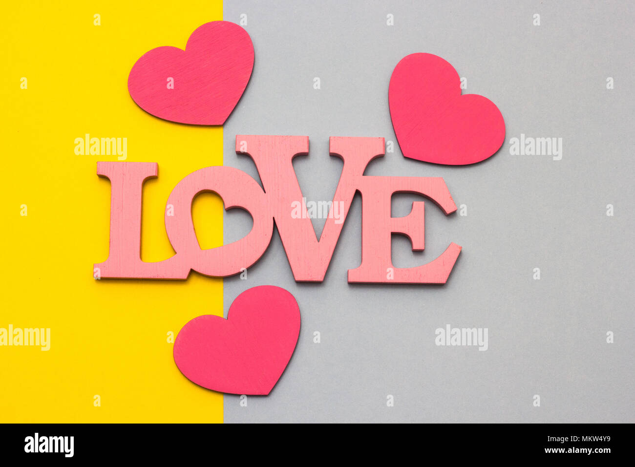 Wooden hearts on a multi-colored background, top view Stock Photo