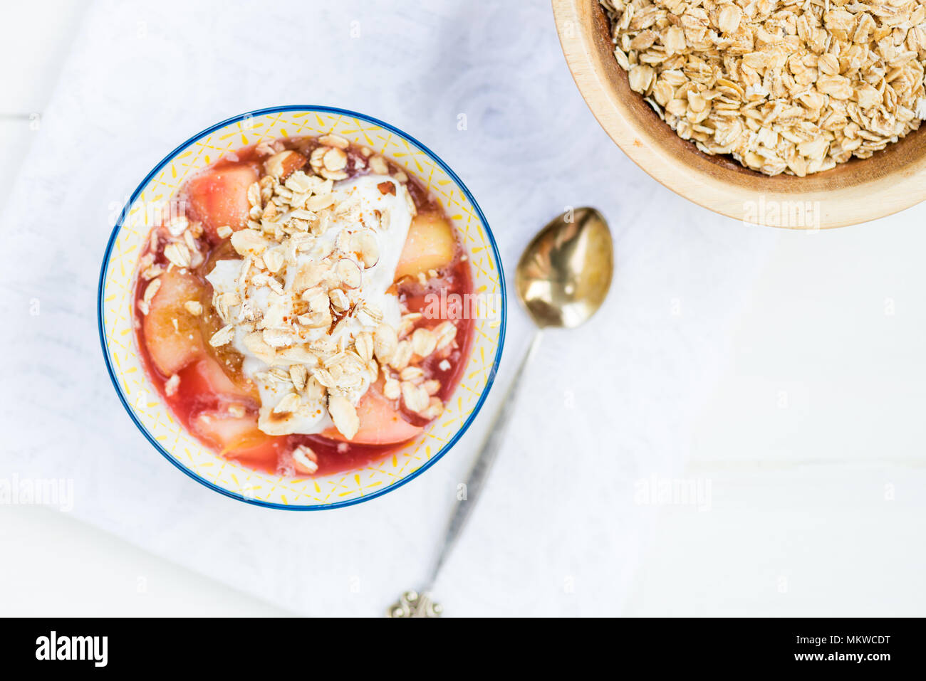 Homemade rhubarb and apple compote with coconut yogurt and oatmeal, healthy detox snack Stock