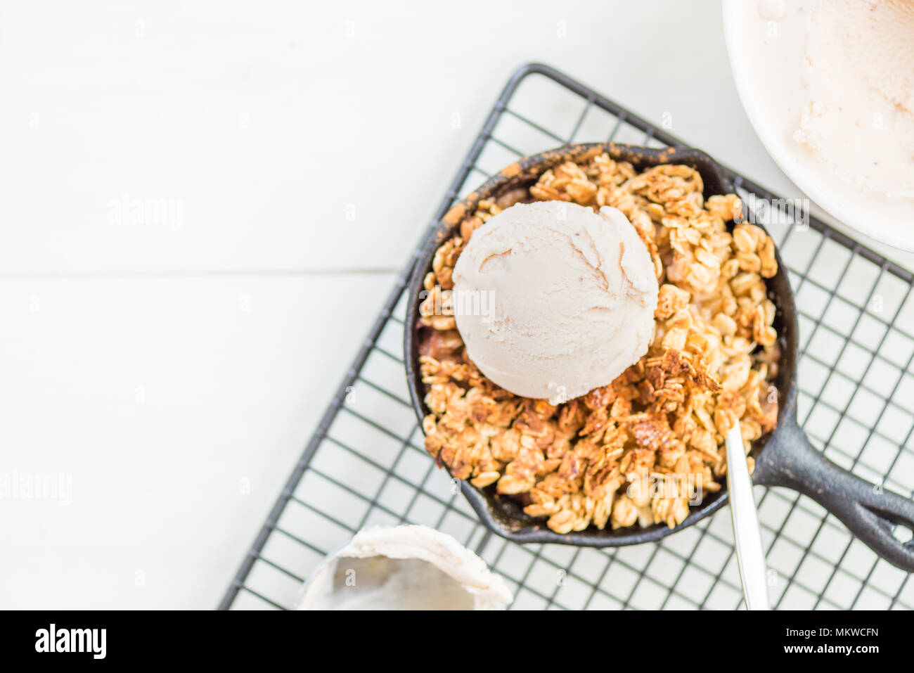 Homemade cooked rhubarb and apple crumble with oatmeal and vanilla ice