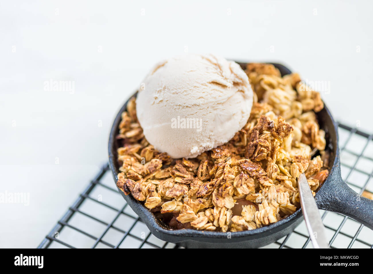 Homemade cooked rhubarb and apple crumble with oatmeal and vanilla ice