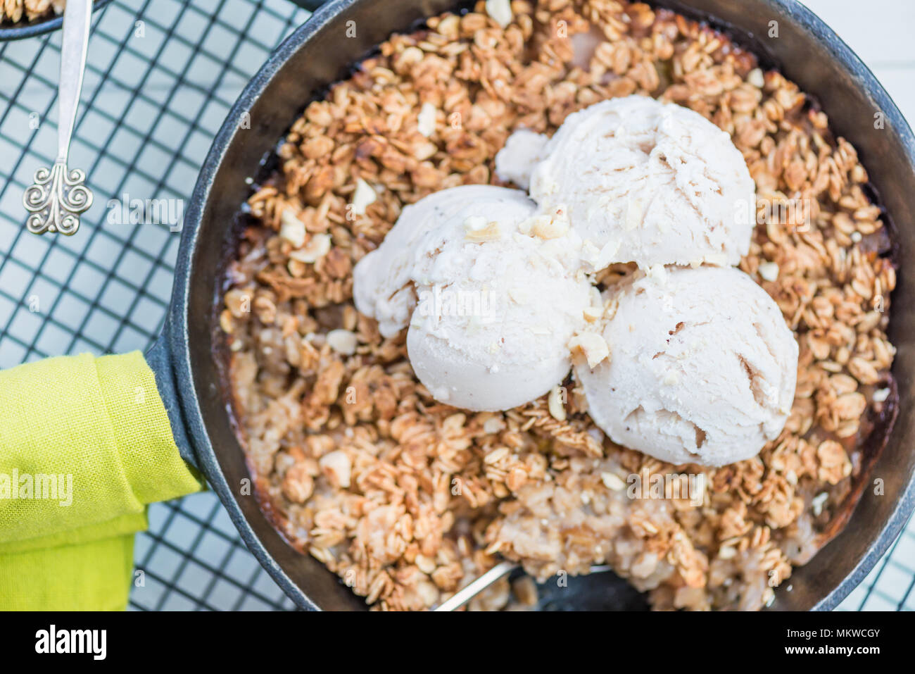 Homemade cooked rhubarb and apple crumble with oatmeal and vanilla ice