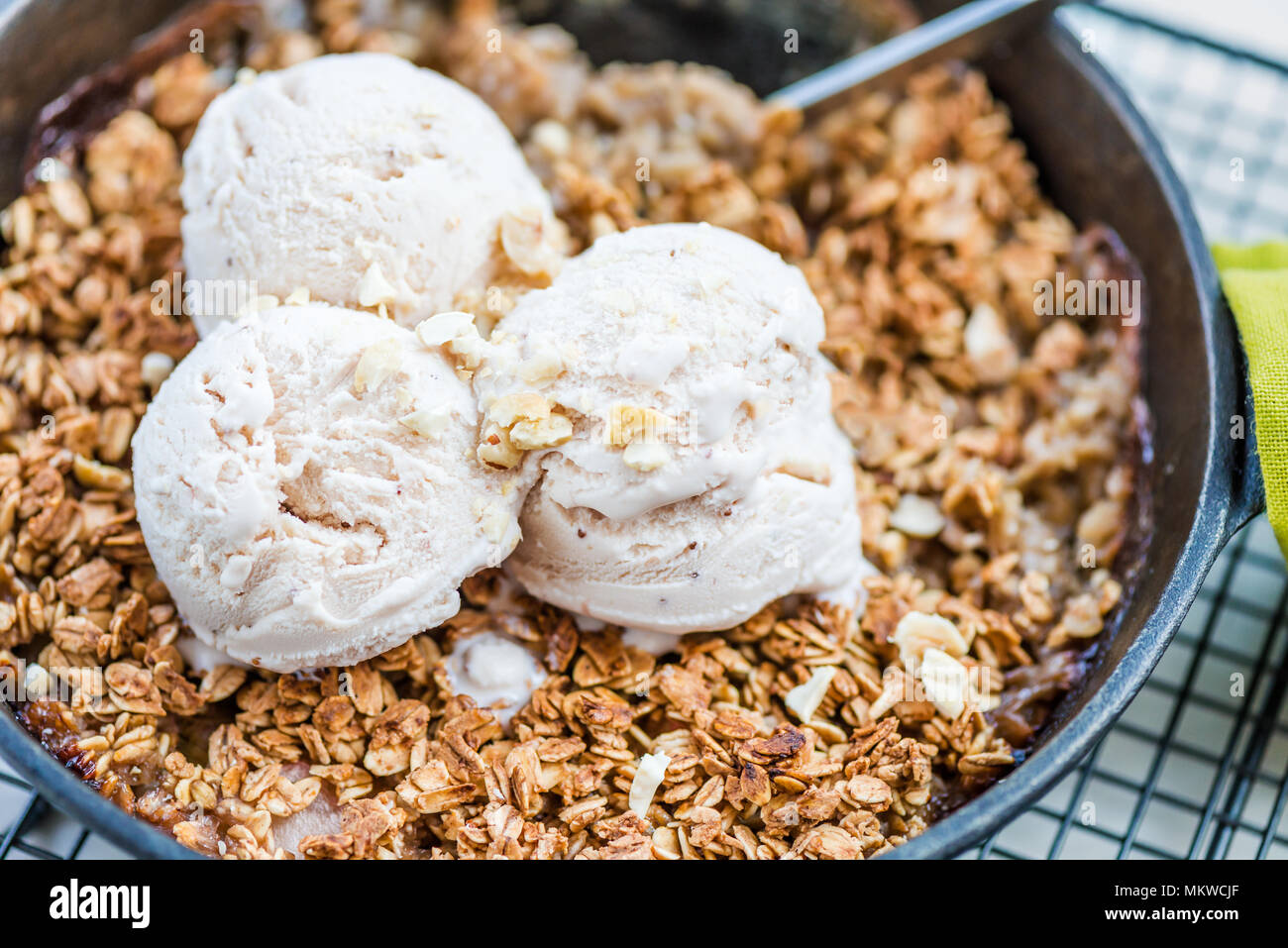 Homemade cooked rhubarb and apple crumble with oatmeal and vanilla ice