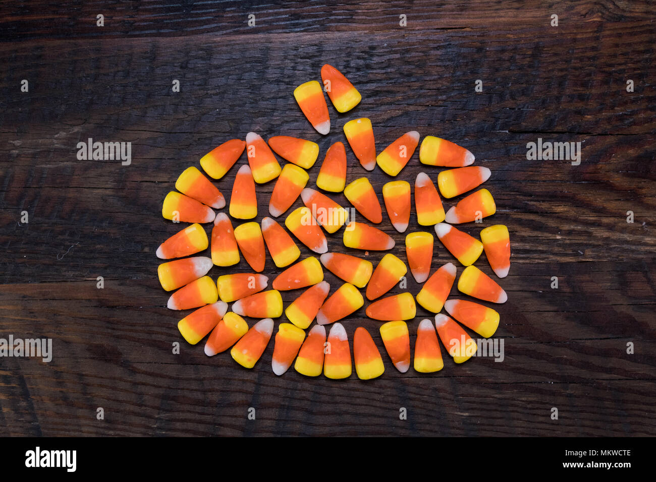 Candy Corn Pumpkin on Charred Wood Background Stock Photo - Alamy