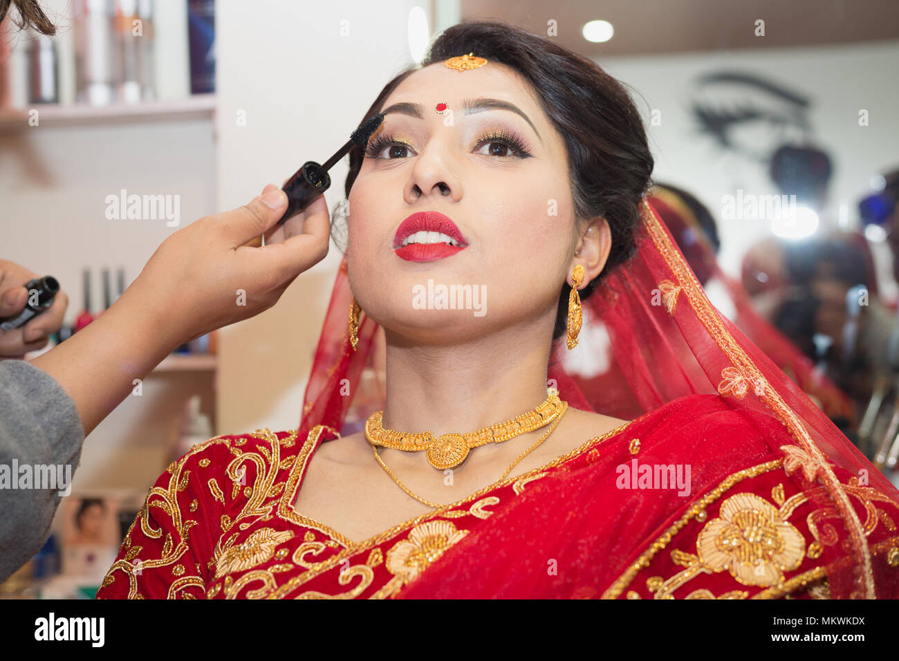 Beautiful Nepali Bride with wedding dress and make up at the Beauty Parlour  in Nepal Stock Photo - Alamy