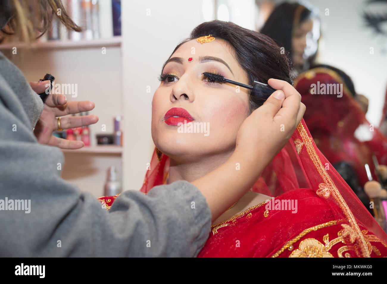 Beautiful Nepali Bride with wedding dress and make up at the Beauty Parlour  in Nepal Stock Photo - Alamy