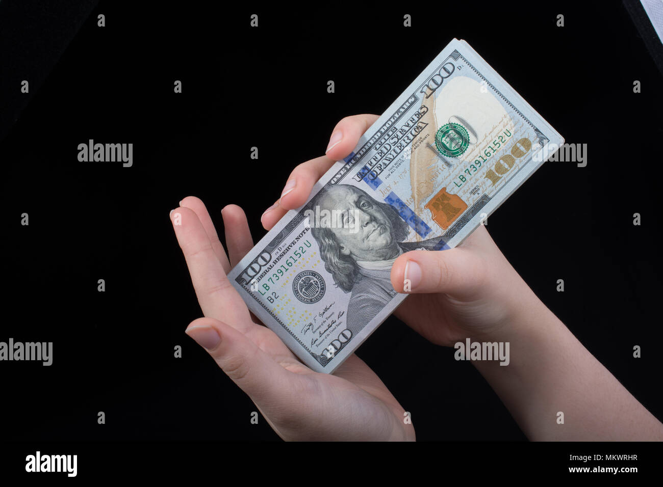 Hand holding American dollar banknotes isolated on white background ...
