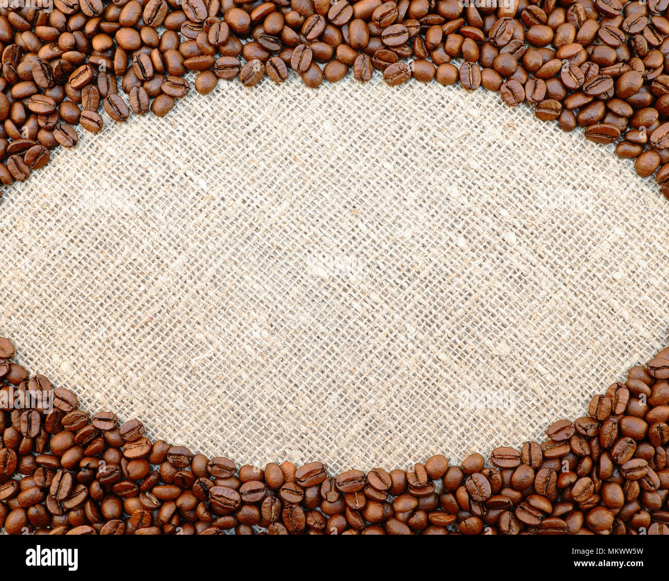 Coffee beans oval frame on natural sacking background with space for your text. Stock Photo