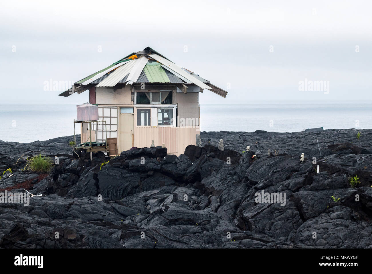 A temporary house stands in the lava fields in the former town of Kalapana in the Puna District on the Big Island of Hawaii. Stock Photo