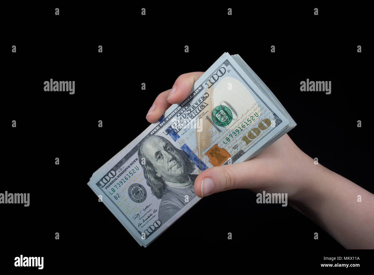 Hand holding American dollar banknotes isolated on white background ...