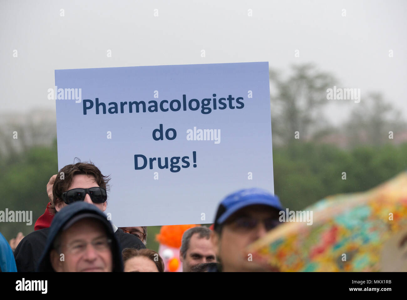 A protest sign reading 'Pharmacologists do drugs' at the March For Science in Washington, D.C. on April 22, 2017. Stock Photo