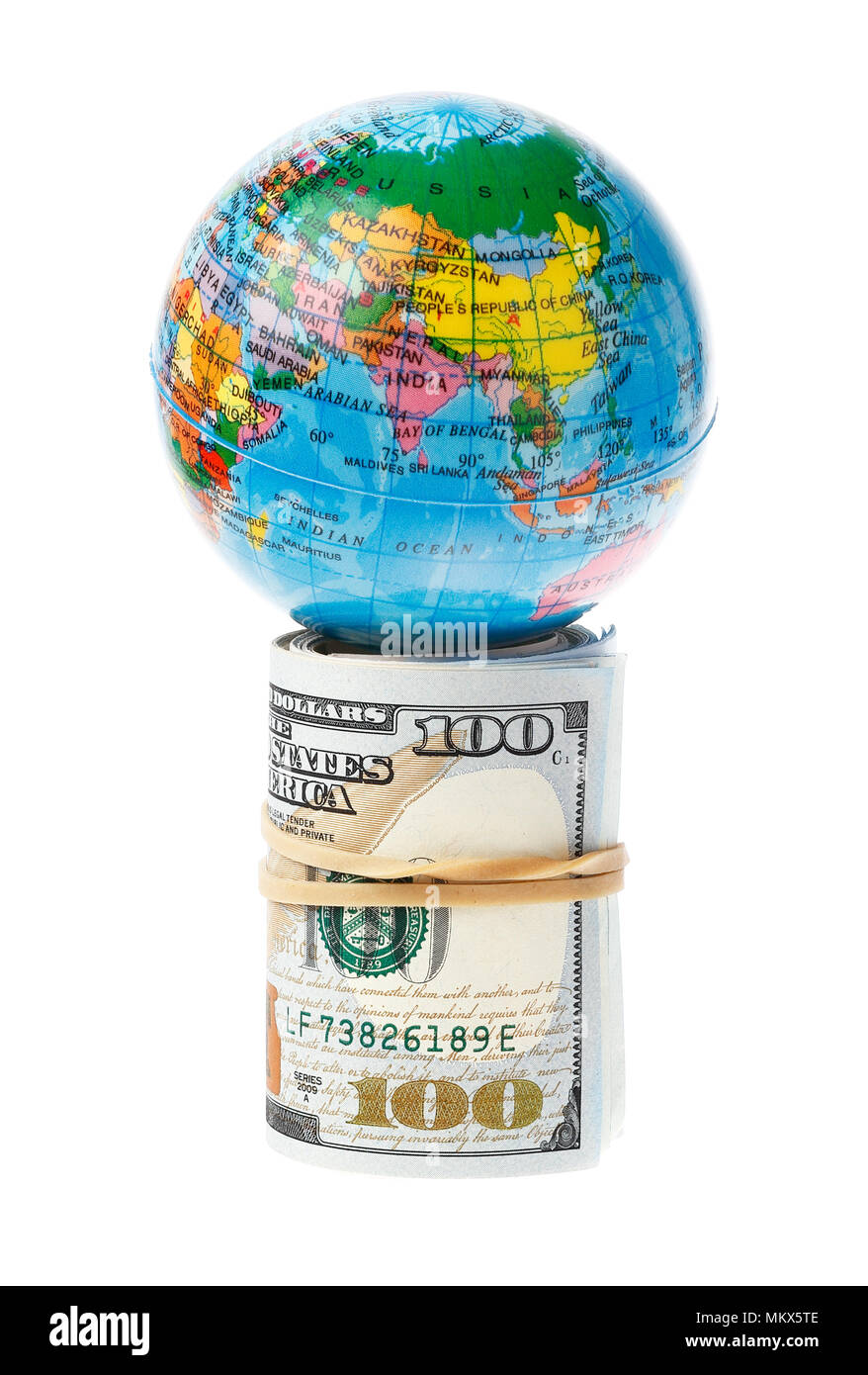 The world supported by a roll of US 100 Dollars bills, isolated on white. Stock Photo