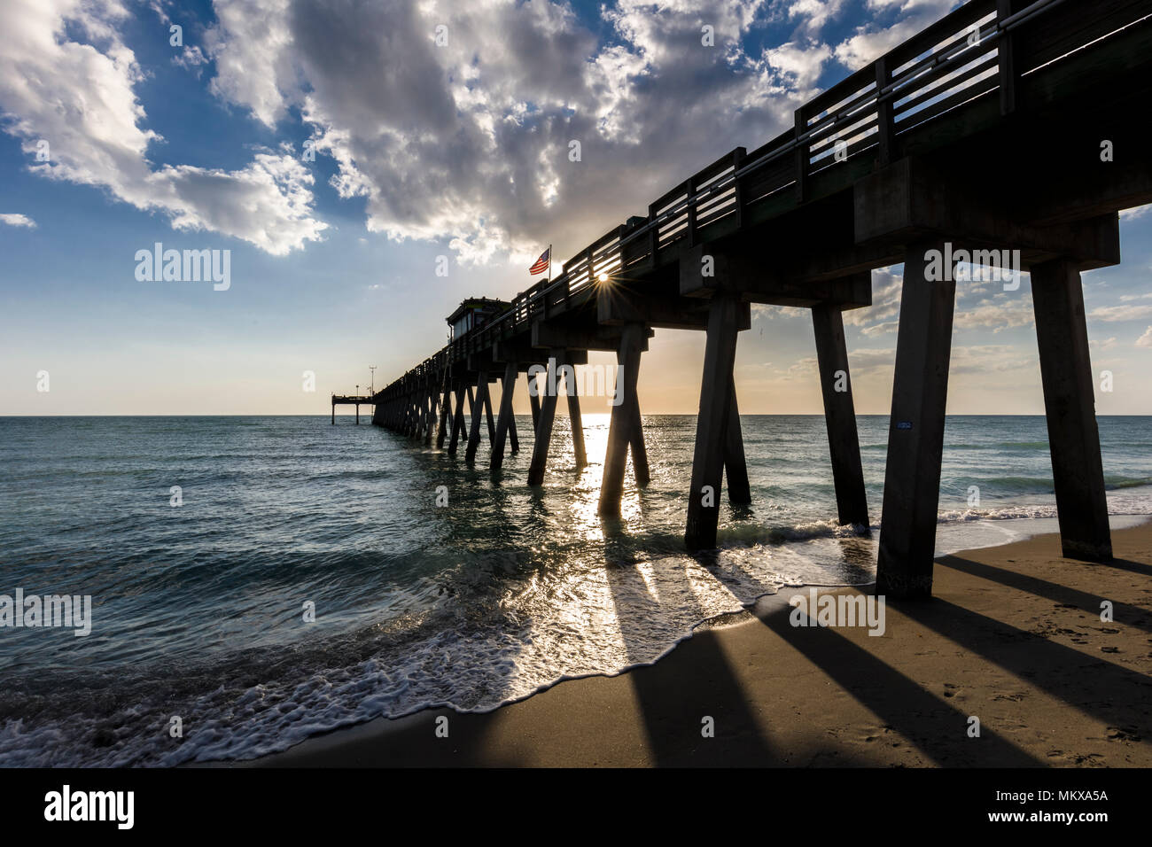 late afternoon sun over Gulf of Mexico and Venice Pier in Venice Florida Stock Photo