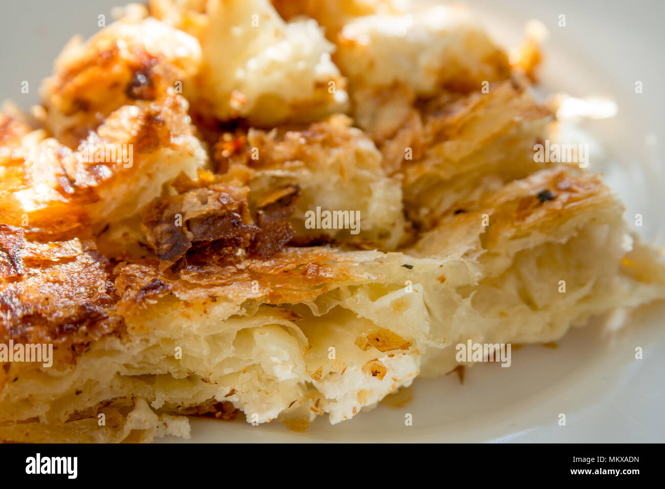 Balkan Bakery Breakfast Serving of Byrek me Gjizë (Burek Cheese Pie with Feta & Flaky Filo Pastry). Close-up Stock Photo