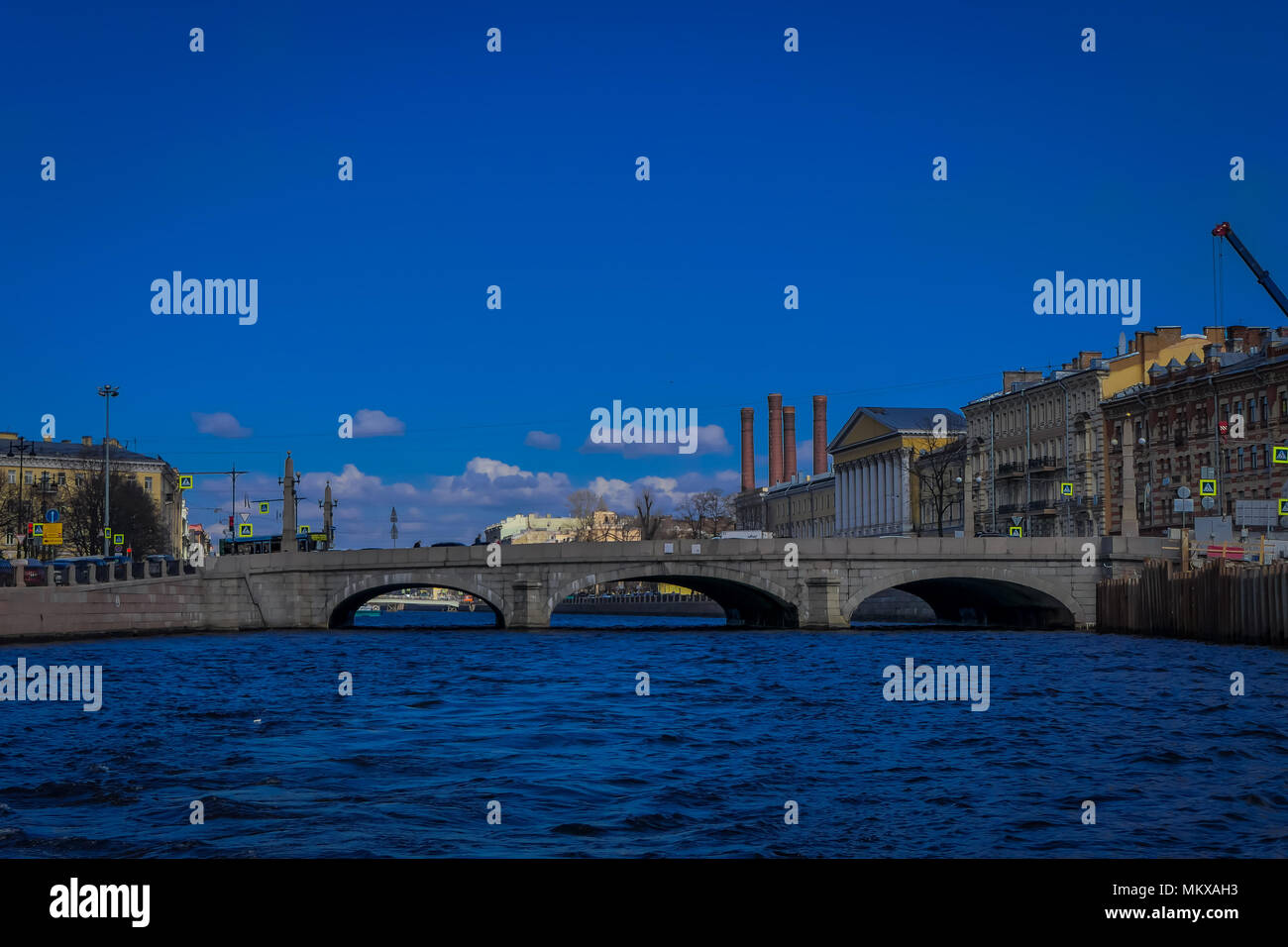 Beautiful outdoor view of Anichkov Bridge on Fontanka river during a sunny day in a blue sky in Saint Petersburg Stock Photo