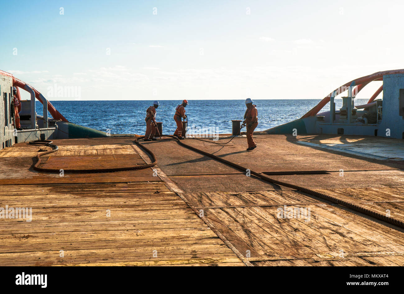AHTS vessel doing static tow tanker lifting. Ocean tug job Stock Photo
