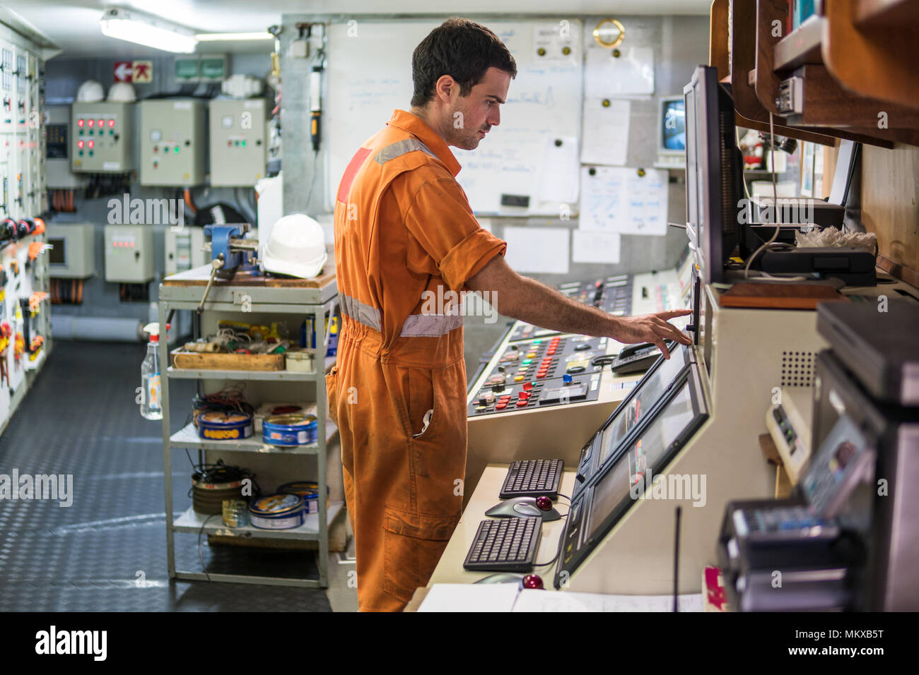 Marine engineer officer starts or stops main engine of ship Stock Photo
