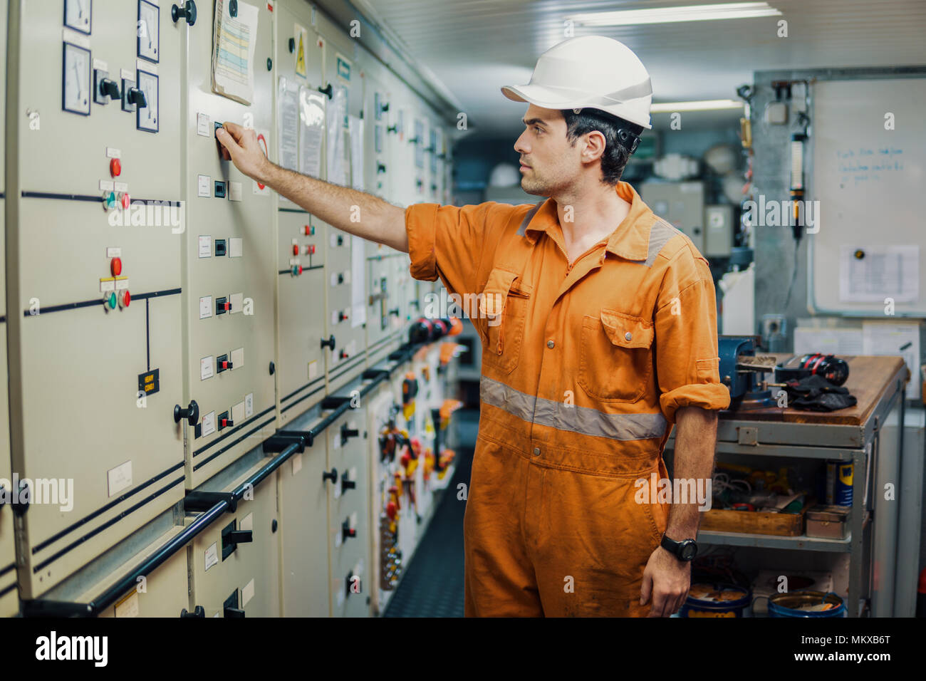 Marine engineer officer starts or stops main engine of ship Stock Photo