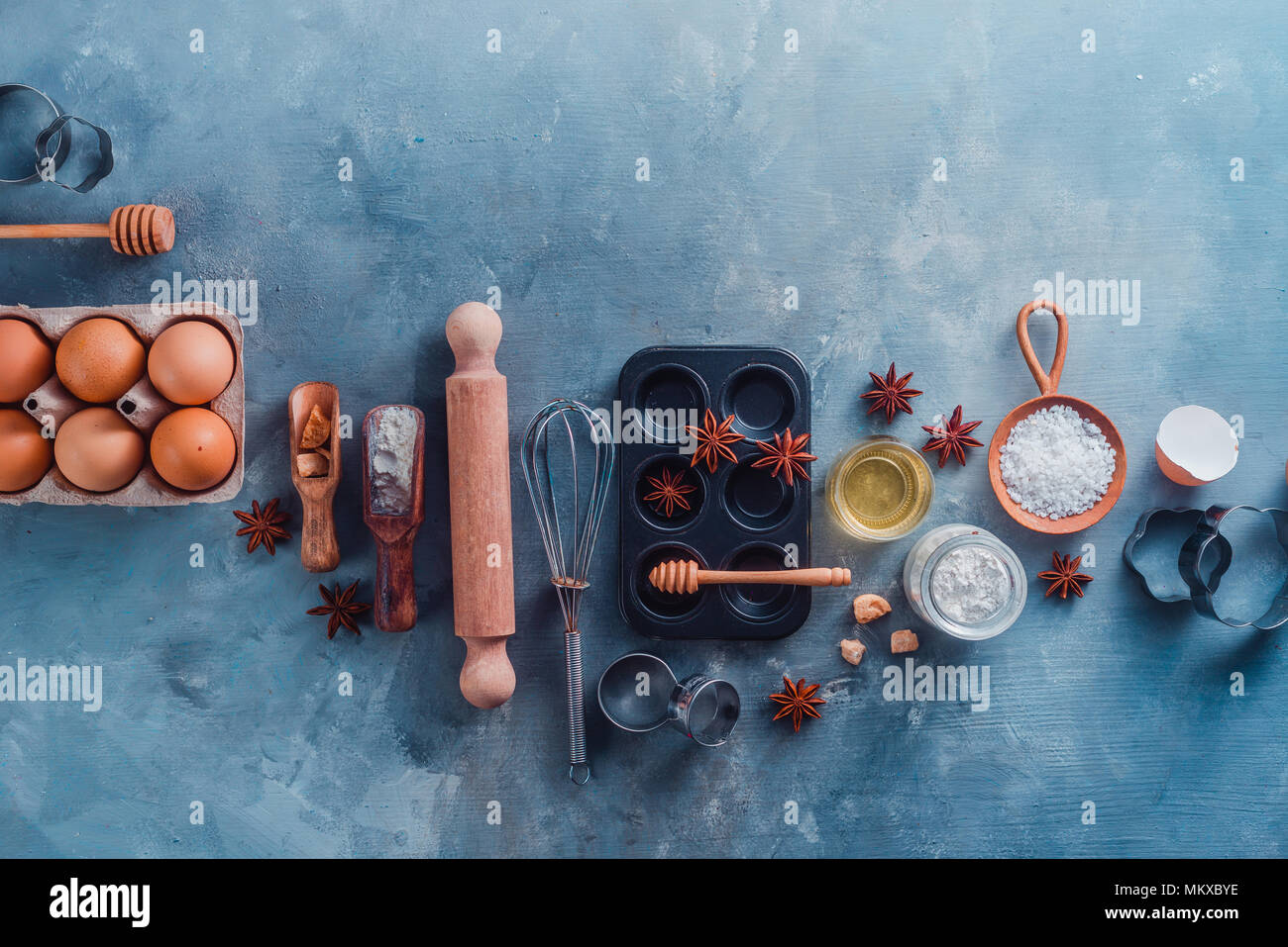 Cooking tools and ingredients from above. Baking concept with measuring  spoons, wooden scoops, whisks, cookie cutters, sugar, flour, eggs and  cinnamon Stock Photo - Alamy