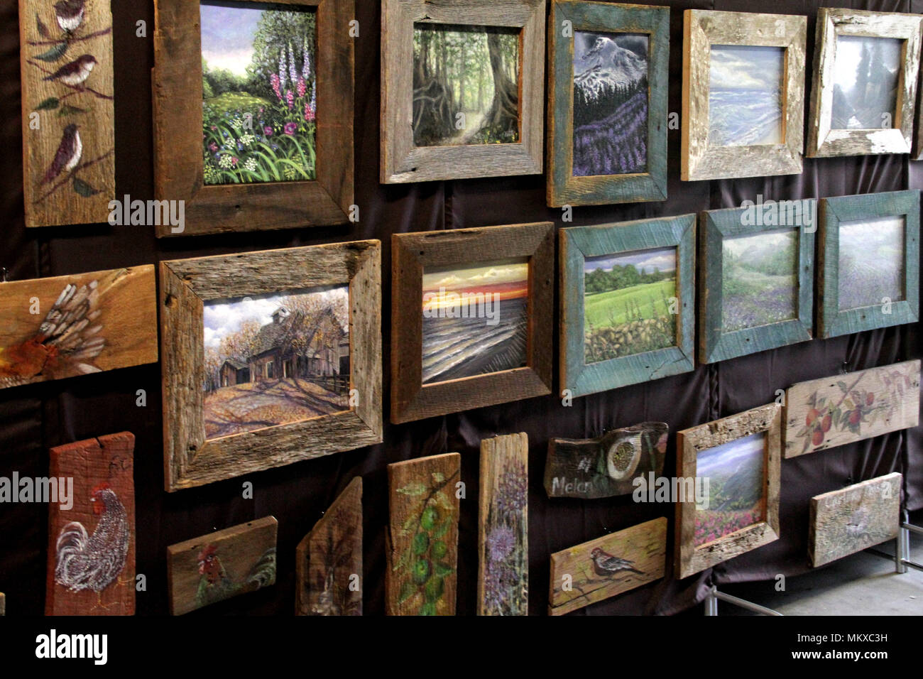 Paintings of nature displayed at art show Stock Photo