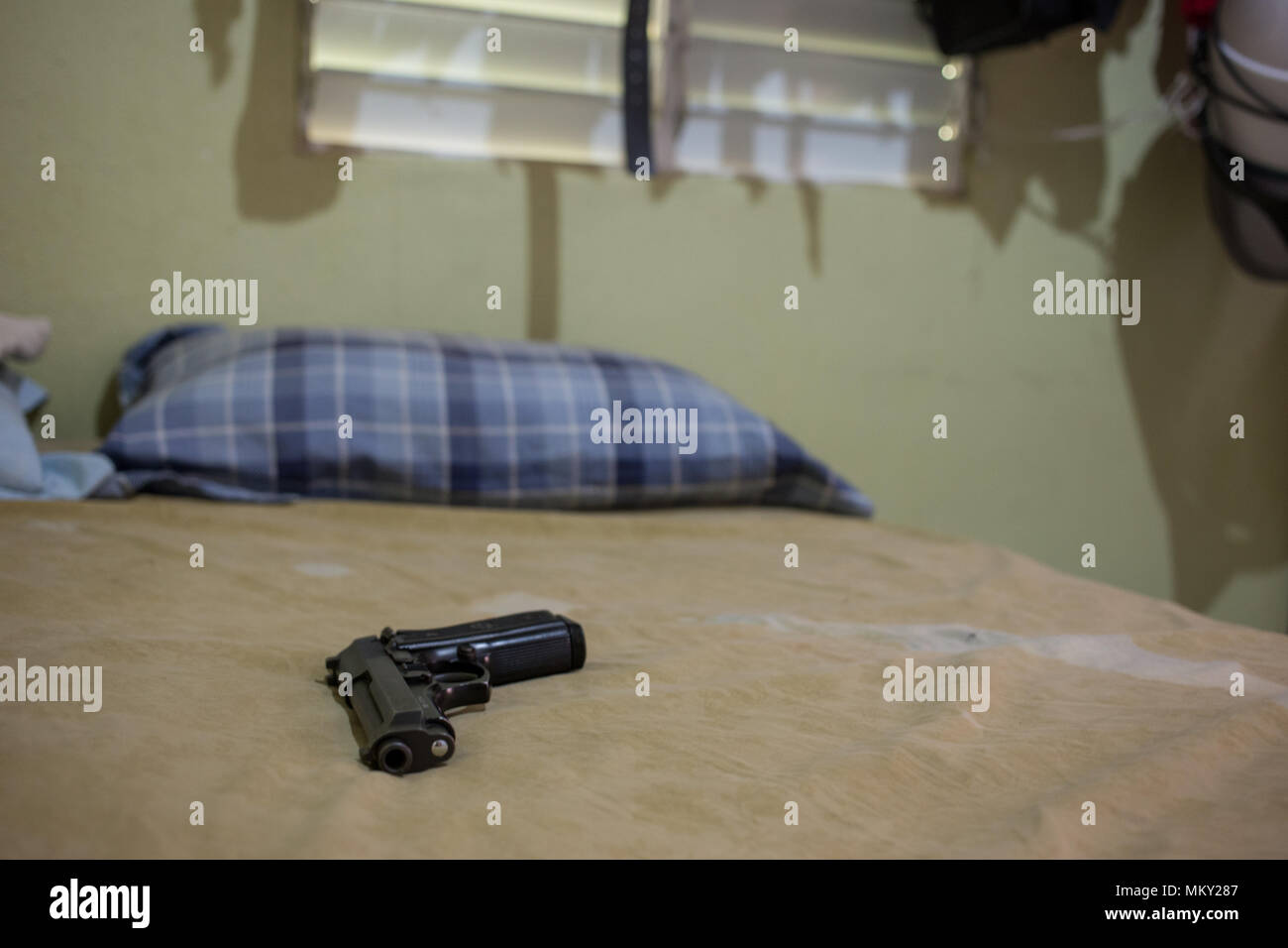 Gun on bed Stock Photo