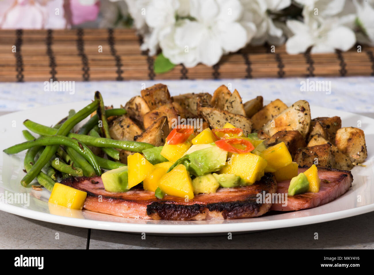Fried ham steaks with spicy mango avacado salsa, fresh green beans, and