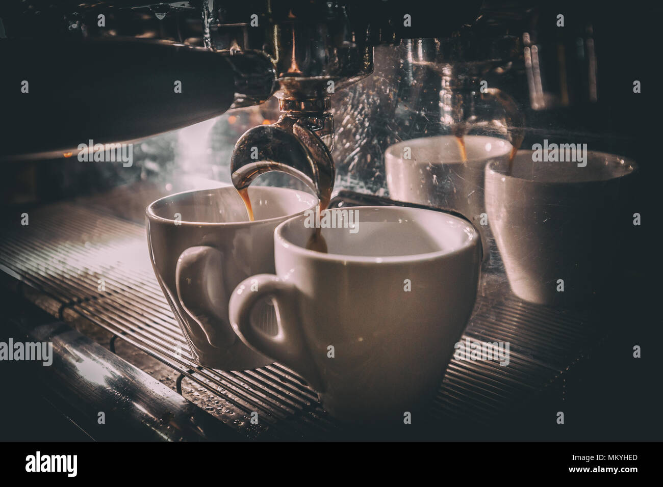 Coffee making in the coffee machine close-up, toned image Stock Photo