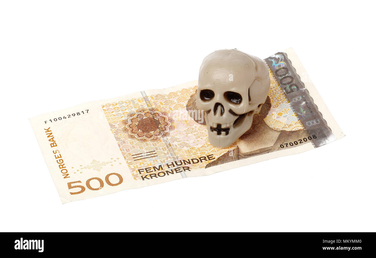 Norwegian 500 kroner bill with a small plastic scull isolated on white background. Stock Photo