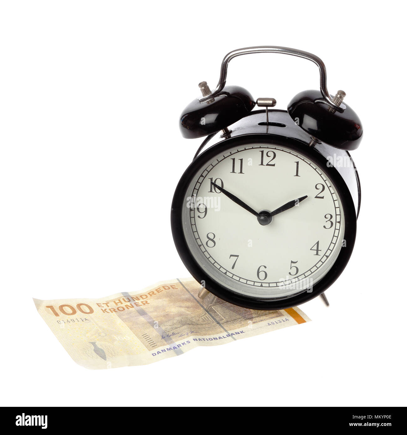 A black alarm clock with happy face on a one hundred Kroner Danish money banknote isolated on white background. Stock Photo