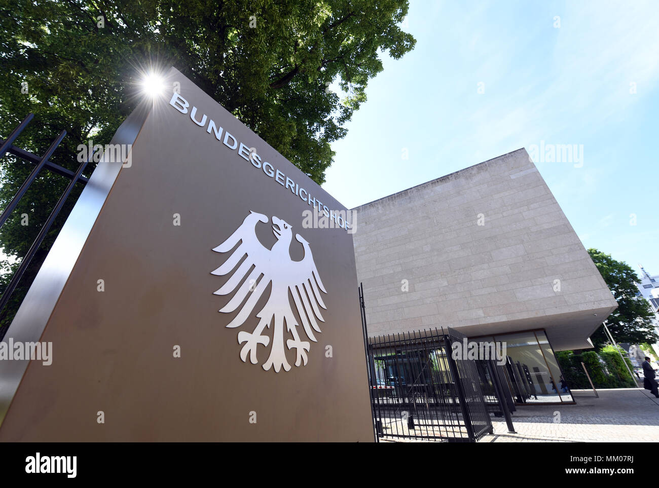 09 May 2018, Germany, Karlsruhe: A sign with the German eagle and the lettering of the Federal Supreme Court. The Federal Supreme Court is negotiating whether the music platform Youtube bears liability for copyright infringements of their users. A music producer has been suing the Google subsidiary for ten years. Photo: Uli Deck/dpa Stock Photo