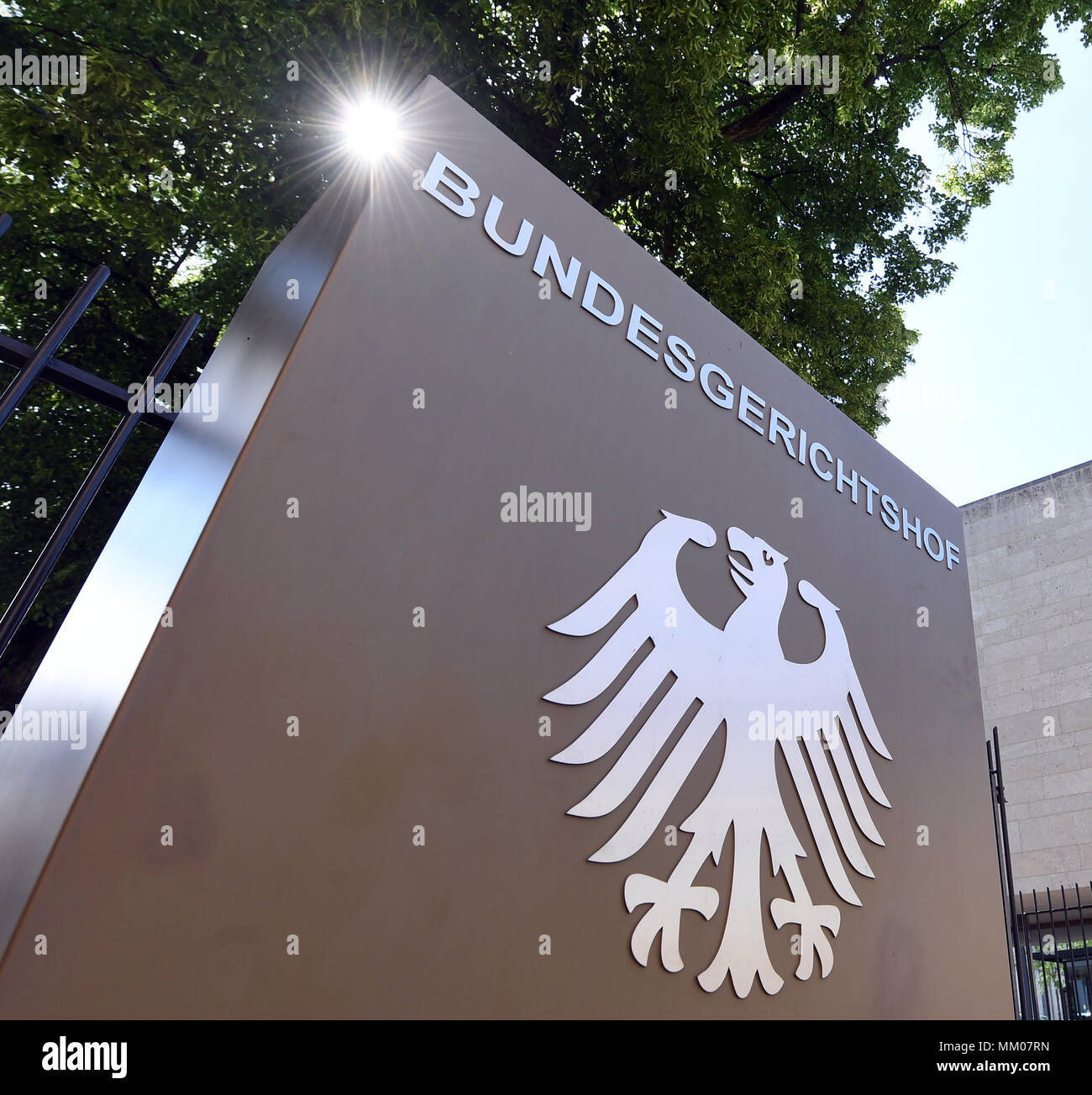 09 May 2018, Germany, Karlsruhe: A sign with the German eagle and the lettering of the Federal Supreme Court. The Federal Supreme Court is negotiating whether the music platform Youtube bears liability for copyright infringements of their users. A music producer has been suing the Google subsidiary for ten years. Photo: Uli Deck/dpa Stock Photo