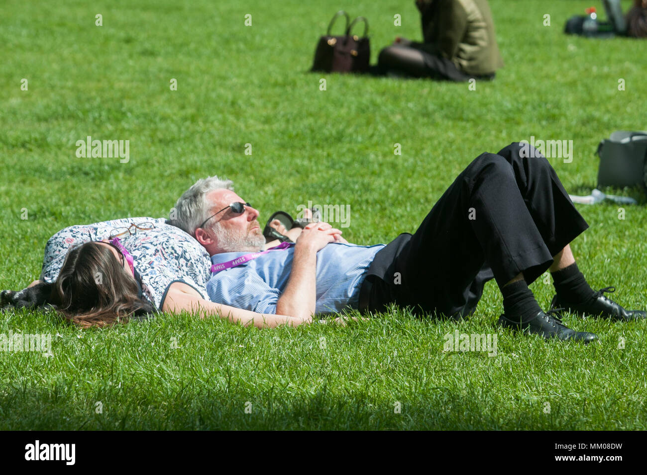 London UK. 9th May 2018. People sunbathing and relaxing the spring sunshine in Victoria Gardens Westminster although temperatures have cooled down after the hot May bank holiday weekend which saw record temperatures Credit: amer ghazzal/Alamy Live News Stock Photo