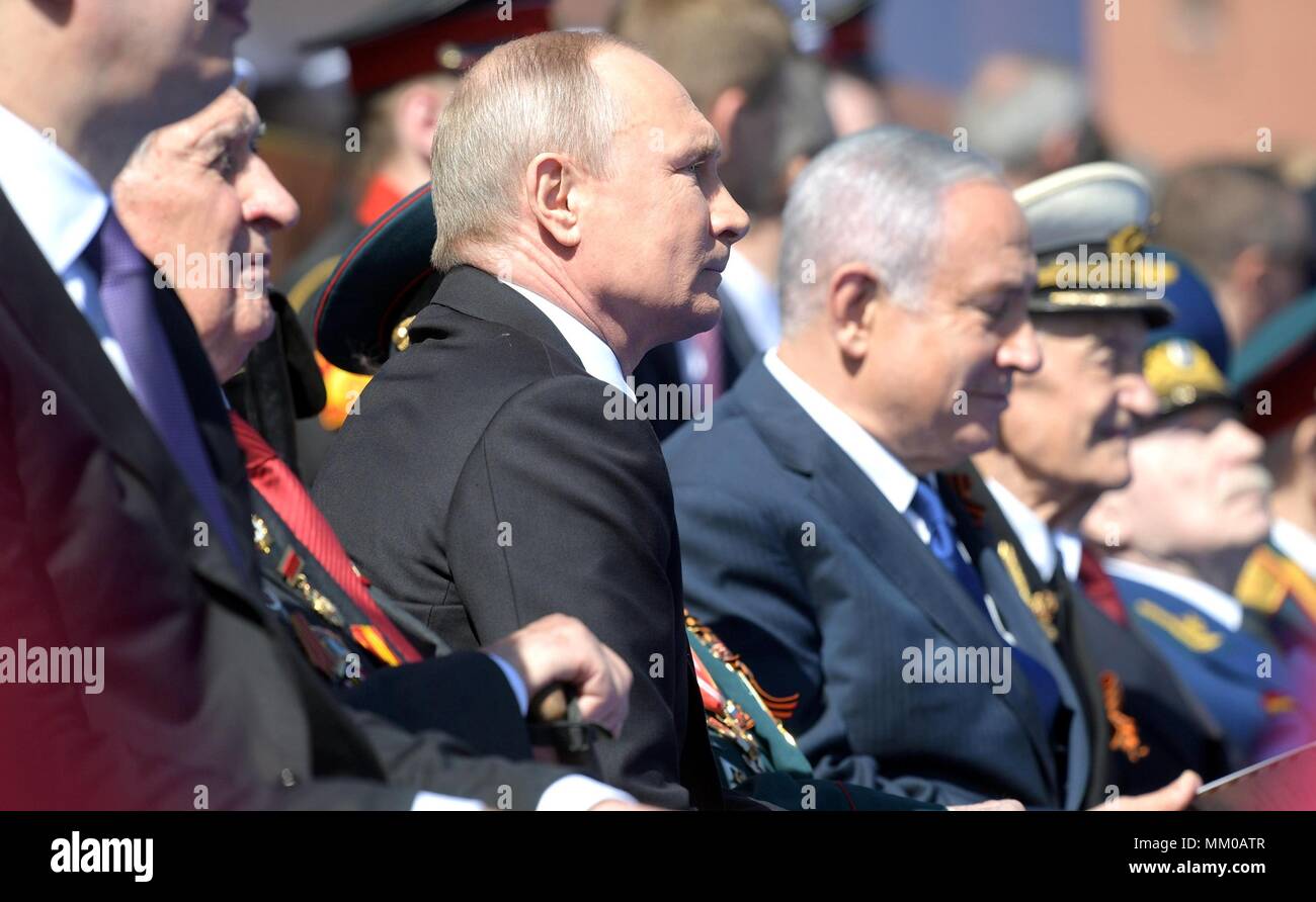 Russian President Vladimir Putin, center, sits with Israeli President Benjamin Netanyahu, left, as they watch the military parade marking the 73rd anniversary of the end of World War II in Red Square May 9, 2018 in Moscow, Russia.  (Russian Presidency via Planetpix) Stock Photo