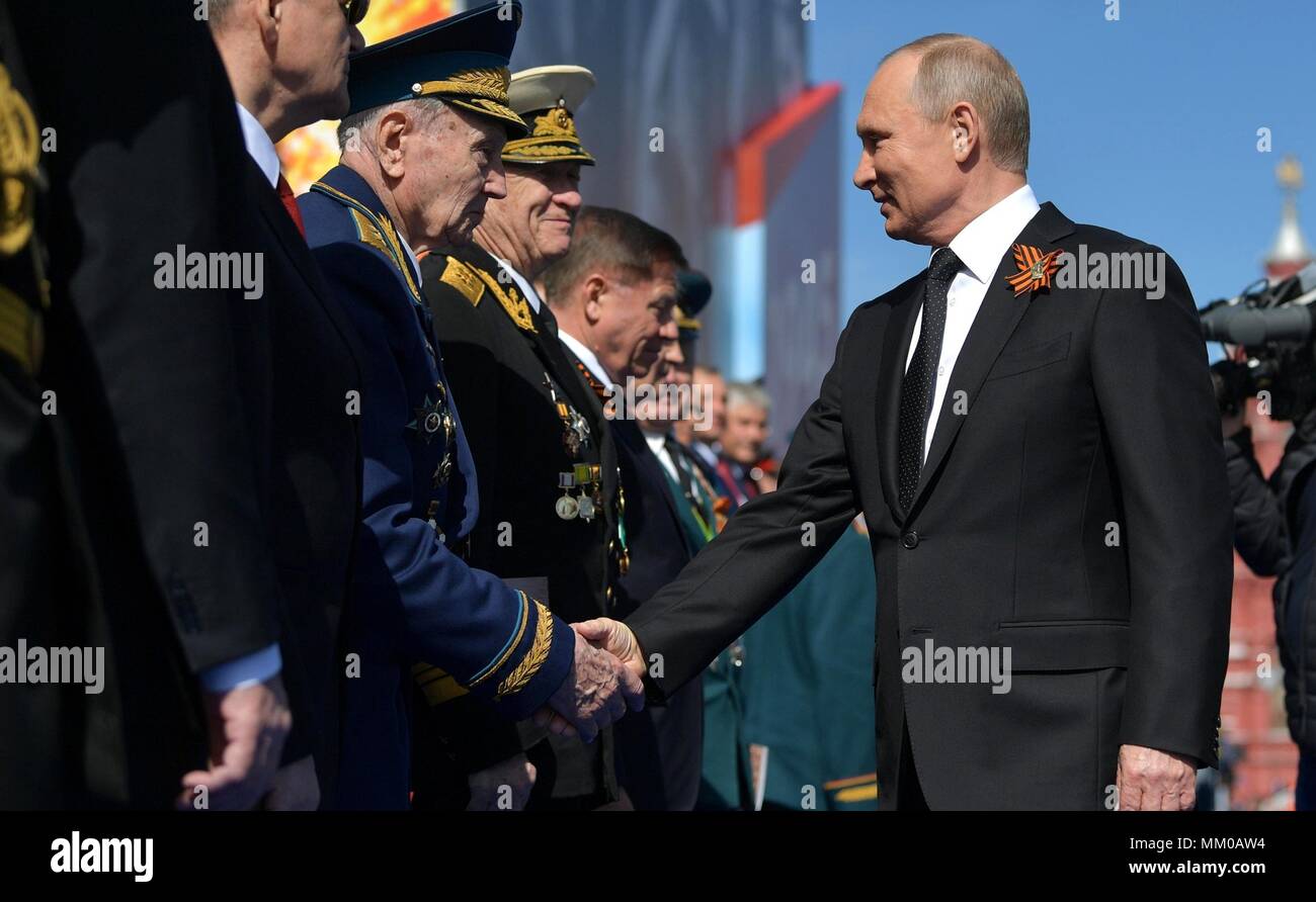 Russian President Vladimir Putin, right, greets veterans before the start of the military parade marking the 73rd anniversary of the end of World War II in Red Square May 9, 2018 in Moscow, Russia.  (Russian Presidency via Planetpix) Stock Photo