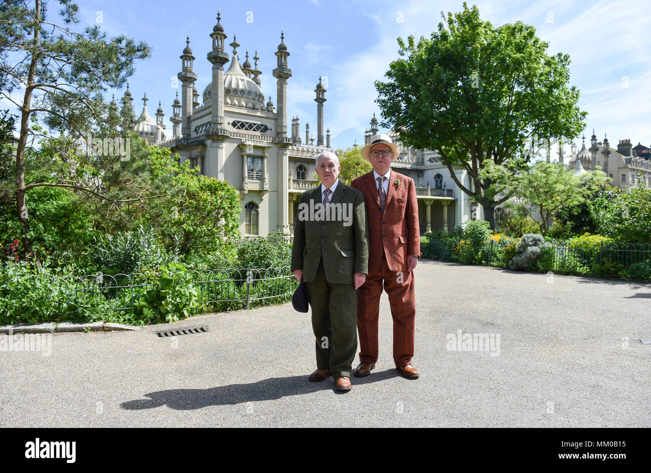 Brighton UK 9th May 2018 - Renowned artists Gilbert (left) and George in the Royal Pavilion Gardens in Brighton before visiting their exhibition at Brighton Museum and Art Gallery which is showing until September until September . Photograph taken by Simon Dack Credit: Simon Dack/Alamy Live News Stock Photo