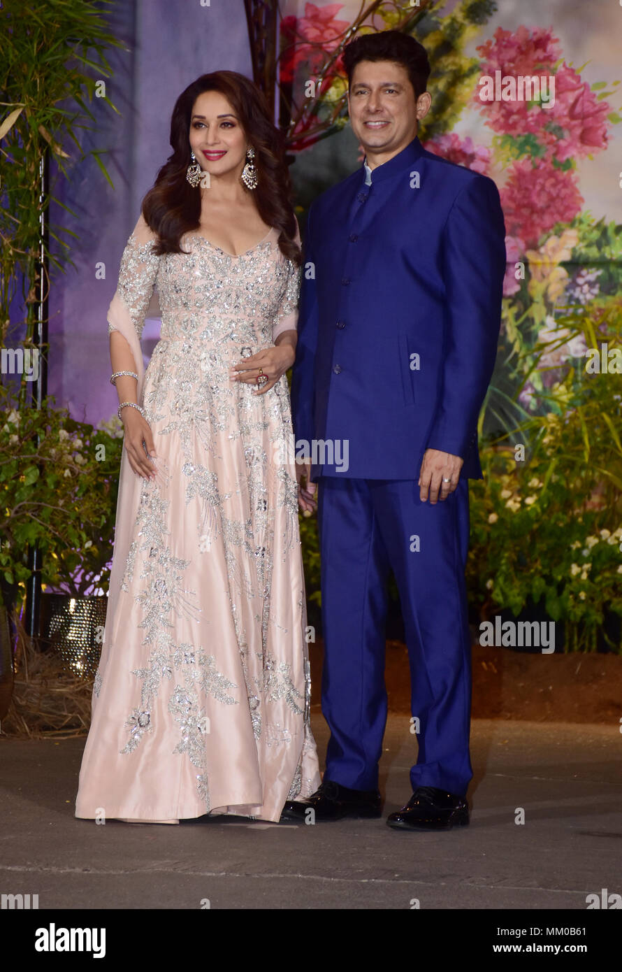 Indian film actress Madhuri Dixit with husband Sriram Nene attend the wedding reception of actress Sonam Kapoor and Anand Ahuja at hotel Leela in Mumbai. Stock Photo