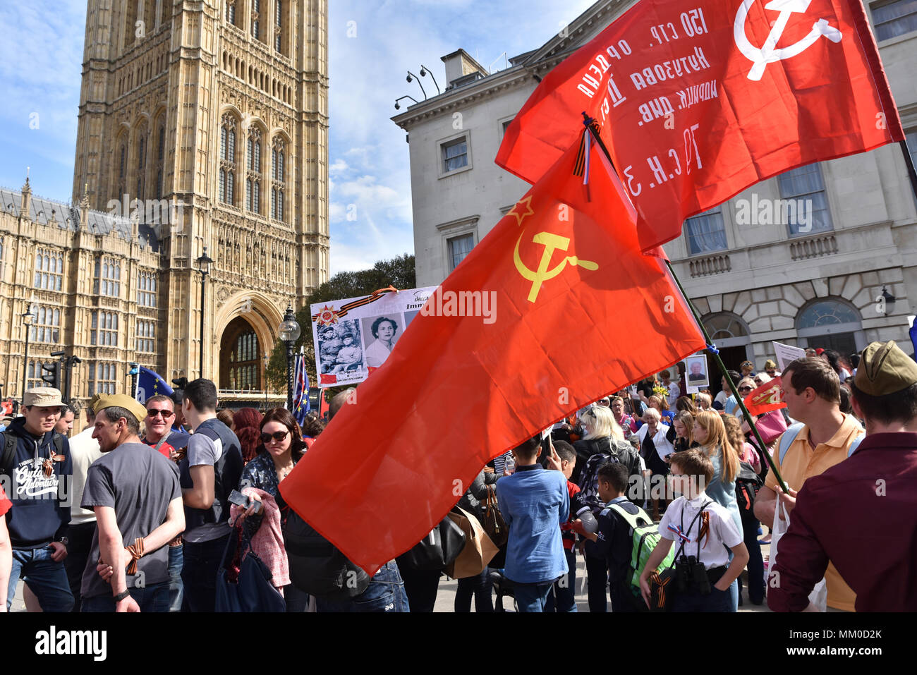 Houses of Parliament, London, UK. 9th May 2018. Russian people and veterans take part in the Immortal Regiment march in London to the Houses of Parliament, carrying pictures of relatives who fought in World War 2 against Nazi Germany . Credit: Matthew Chattle/Alamy Live News Stock Photo