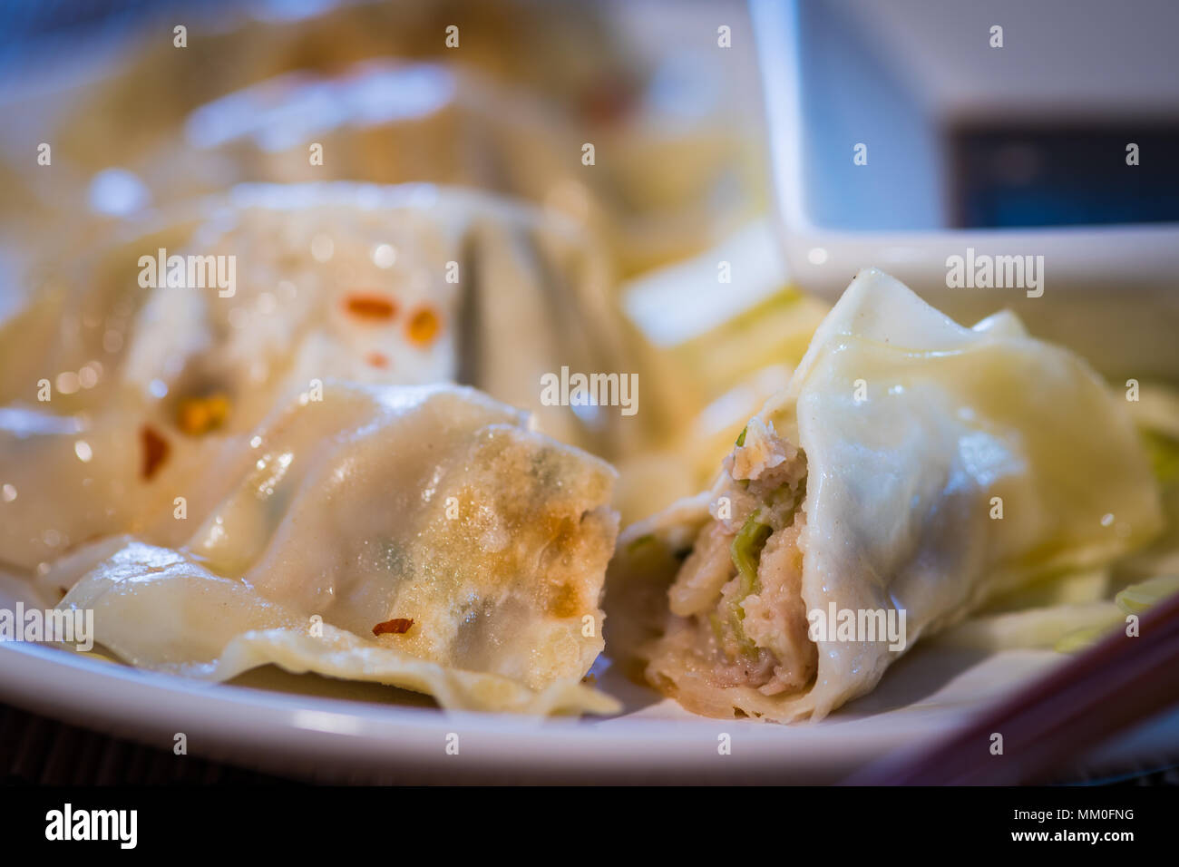 Plate of pork and vegetable Chinese potsticker dumplings with ginger