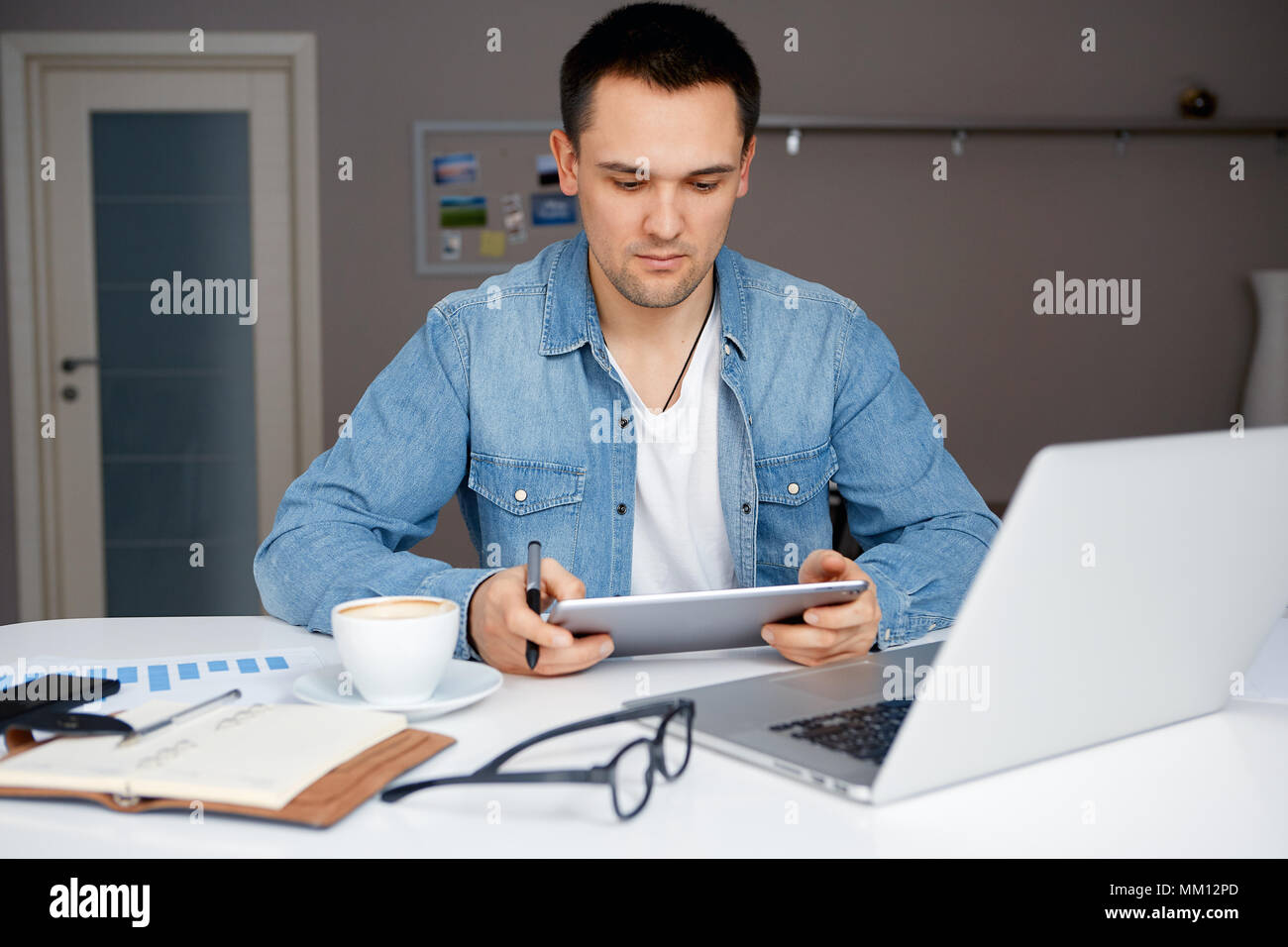 Man working from home on his laptop Stock Photo