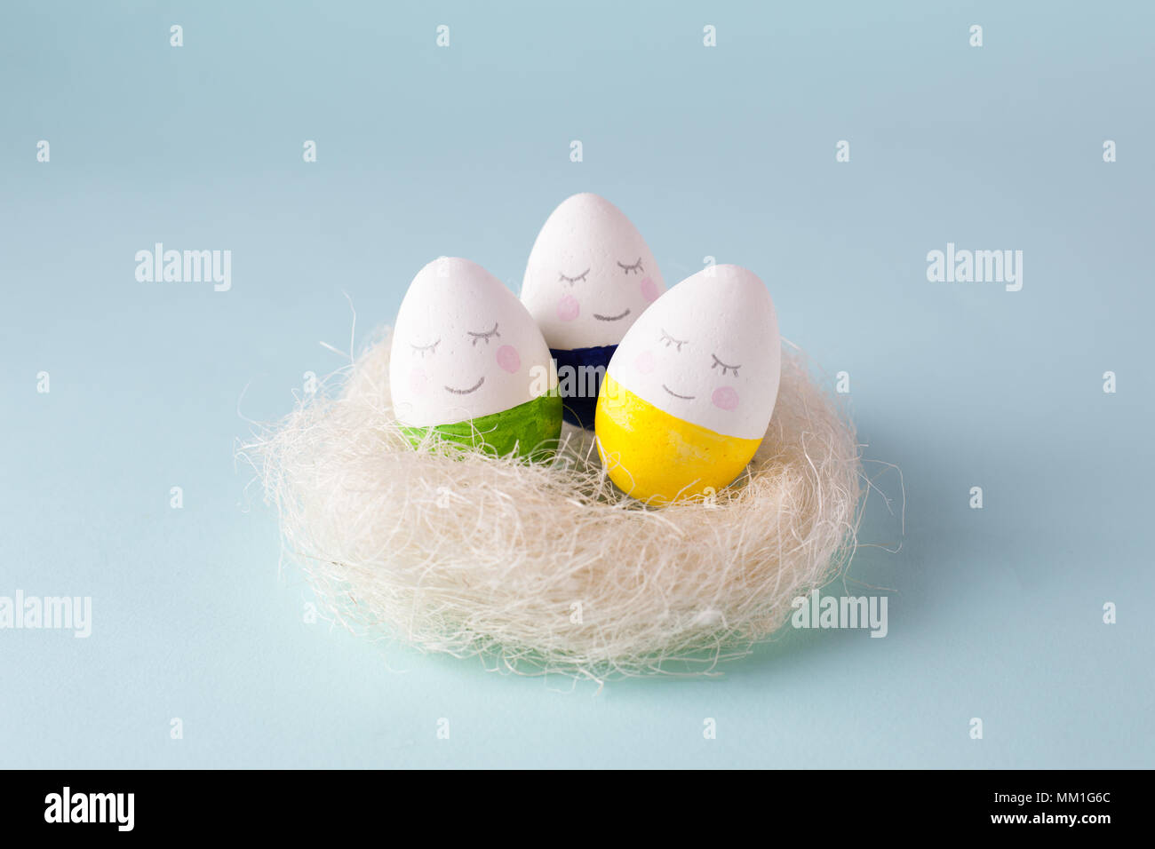 funny cute eggs in the nest jon blue pastel background, trendy unplug relaxation concept Stock Photo