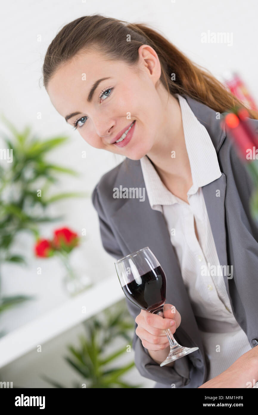 young woman holds a glass of red wine Stock Photo