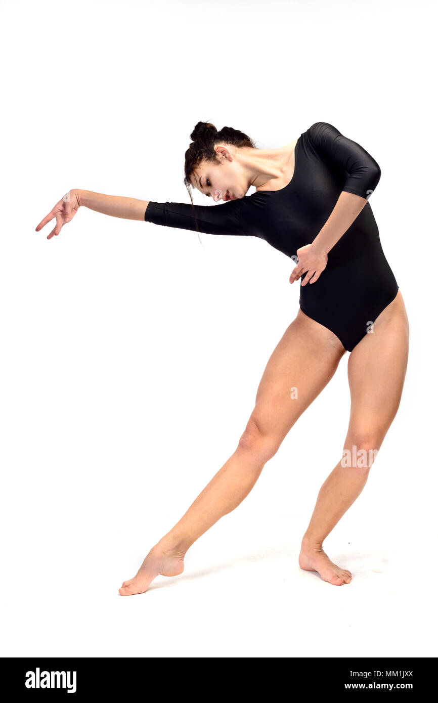 A girl in a brown bodysuit is doing stretching excercises (isolation on white) Stock Photo