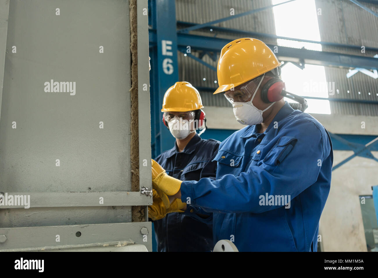 Two blue-collar workers wearing protective equipment  Stock Photo