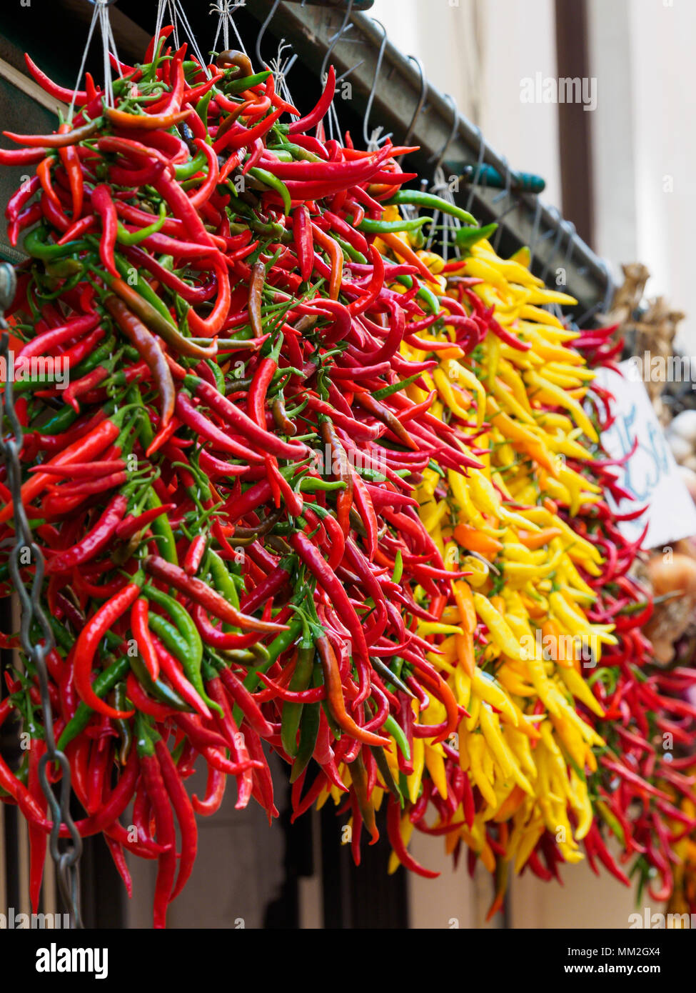 Peppers hanging on fruit & veg stall Stock Photo - Alamy