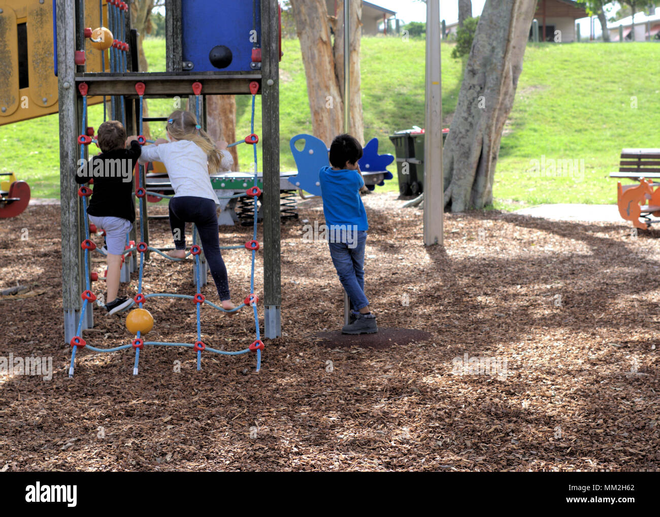 Children playing in park in Australia, Coffs Harbour. Kids climbing on ride. Stock Photo